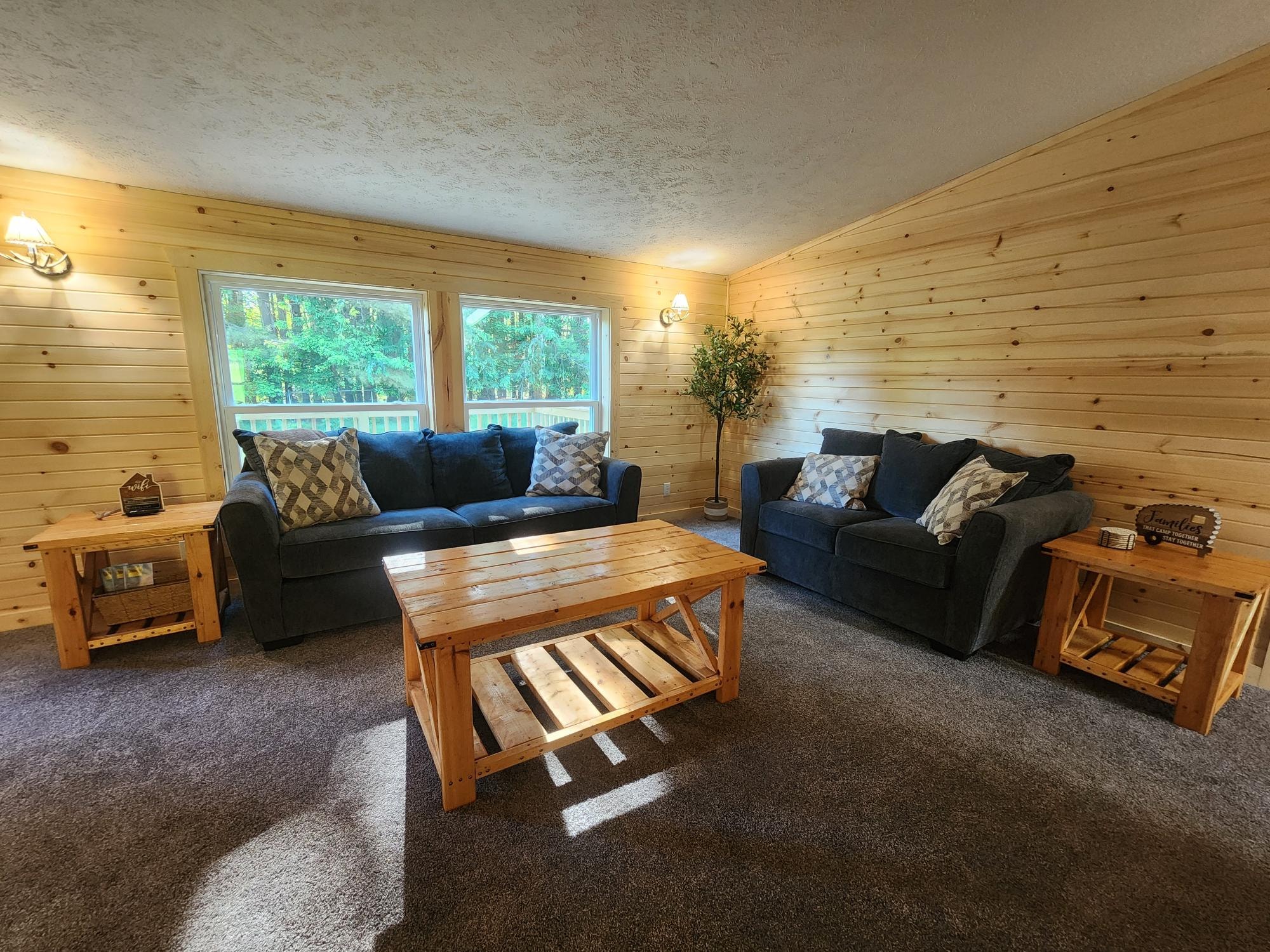 Living Room with Blue Sofas & Wood Paneling